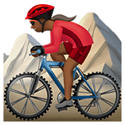 🚵🏾‍♀️ Emoji Mulher Fazendo Mountain Bike: Pele Morena Escura na Apple iOS 12.1.