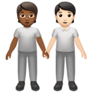🧑🏾‍🤝‍🧑🏻 Emoji sich an den Händen haltende Personen: mitteldunkle Hautfarbe, helle Hautfarbe Apple iOS 17.4.