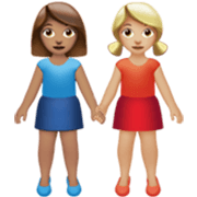 👩🏽‍🤝‍👩🏼 Emoji Mujeres De La Mano: Tono De Piel Medio Y Tono De Piel Claro Medio en Apple iOS 17.4.