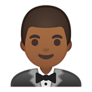 🤵🏾 Emoji Persona Con Esmoquin: Tono De Piel Oscuro Medio en Google Android 10.0 March 2020 Feature Drop.