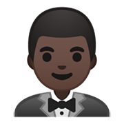 🤵🏿 Emoji Persona Con Esmoquin: Tono De Piel Oscuro en Google Android 10.0.
